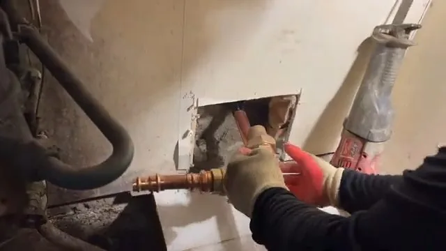 Removed lead service pipe covered in soil pictured on a burst pipe repair call near Frederick.
